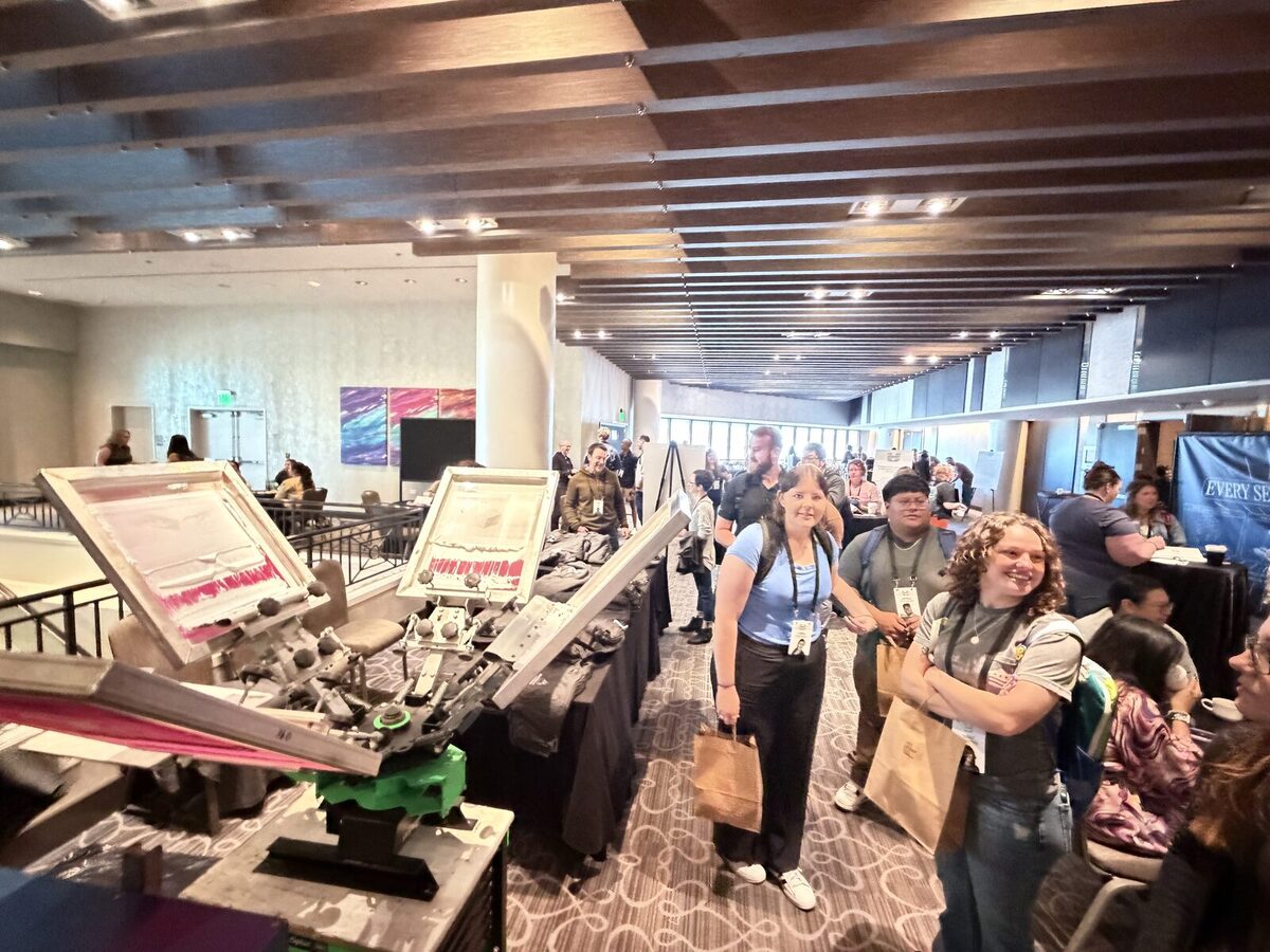 Convention crowd gathered around a live merch activation